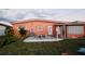 The backyard offers a patio with seating and well kept grass at 22032 Felton Ave, Port Charlotte, FL 33952