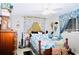 Bright bedroom featuring a bed with seashell-patterned bedding, a dresser, and a window with patterned curtains at 22032 Felton Ave, Port Charlotte, FL 33952