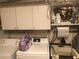 Functional laundry room with storage cabinets, sink, and newer model washer and dryer units at 22032 Felton Ave, Port Charlotte, FL 33952