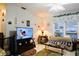 Inviting living room with a large window, comfortable seating, and a modern television set on a wooden stand at 22032 Felton Ave, Port Charlotte, FL 33952