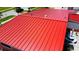 Aerial view of a vibrant red metal roof, offering durability and modern appeal to the home at 22032 Felton Ave, Port Charlotte, FL 33952