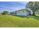 Well maintained backyard with lush lawn, screened-in patio, and a clean exterior at 224 Pine Glen Ct, Englewood, FL 34223