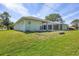 Expansive backyard featuring a screened-in porch and plenty of green space at 224 Pine Glen Ct, Englewood, FL 34223