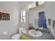 Bathroom featuring a vanity, toilet, and a mirror. A sign on the wall reads 