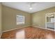 Empty bedroom featuring hard floors, a window, and access to a bathroom at 224 Pine Glen Ct, Englewood, FL 34223