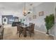 Inviting dining area open to the living room featuring a decorative chandelier and stylish furnishings at 224 Pine Glen Ct, Englewood, FL 34223