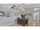 Charming dining area with stylish furnishings, decorative lighting, and an adjacent hallway at 224 Pine Glen Ct, Englewood, FL 34223