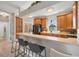 Charming kitchen with wood cabinetry, a convenient breakfast bar, and ample counter space at 224 Pine Glen Ct, Englewood, FL 34223