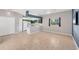 Bright living room with tile flooring and kitchen with modern appliances at 224 Pine Glen Ct, Englewood, FL 34223