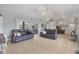 Spacious living room featuring neutral tones, tile flooring, and access to outdoor spaces at 224 Pine Glen Ct, Englewood, FL 34223