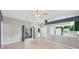 Bright living room with tile floors, ceiling fan, and an adjacent kitchen area at 224 Pine Glen Ct, Englewood, FL 34223