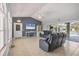 Bright living room with comfortable seating and views of the pool area at 224 Pine Glen Ct, Englewood, FL 34223