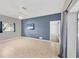 Open-plan living room with tile flooring, ceiling fan, wall-mounted TV, and sliding glass doors at 224 Pine Glen Ct, Englewood, FL 34223