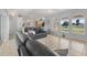Inviting living room with tile floors, large windows, and comfortable seating arrangement at 224 Pine Glen Ct, Englewood, FL 34223