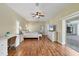 Large main bedroom with hard floors, a ceiling fan, an attached office area and pool access at 224 Pine Glen Ct, Englewood, FL 34223