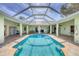 Lovely view of a screened-in pool and deck, ideal for relaxation and entertainment at 224 Pine Glen Ct, Englewood, FL 34223