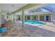 Enclosed pool area features a screened enclosure, tile floors, and ample space for entertaining at 224 Pine Glen Ct, Englewood, FL 34223