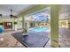 Inviting pool with screened enclosure surrounded by tile flooring, with outdoor table and ceiling fans at 224 Pine Glen Ct, Englewood, FL 34223