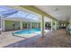 Sparkling pool within a screened lanai featuring tile decking, spacious seating, and an outdoor shower at 224 Pine Glen Ct, Englewood, FL 34223