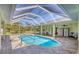 Enclosed pool with tiled deck and serene views, offering relaxation and privacy at 224 Pine Glen Ct, Englewood, FL 34223
