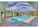 Enclosed sparkling pool with tiled deck, perfect for outdoor enjoyment and leisure at 224 Pine Glen Ct, Englewood, FL 34223