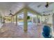 Outdoor screened-in pool featuring an expansive patio, ceiling fans, and exterior access doors at 224 Pine Glen Ct, Englewood, FL 34223