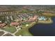 Expansive aerial view of a resort community with a golf course, lakes, and a large community center at 23781 Waverly Cir, Venice, FL 34293