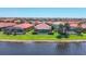 An aerial shot of homes with screened lanais with stunning lake views in a vibrant community at 23781 Waverly Cir, Venice, FL 34293