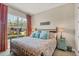 Cozy bedroom features a large window with natural light, comfortable bedding, and side tables at 23781 Waverly Cir, Venice, FL 34293