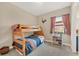 bedroom with bunk beds, showcasing a window with natural light and a storage chest at 23781 Waverly Cir, Venice, FL 34293