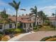 Lovely clubhouse with tile roof, inviting entrance, and beautifully manicured landscaping at 23781 Waverly Cir, Venice, FL 34293