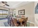 Dining room with wooden table and seating for ten overlooking the pool and lake at 23781 Waverly Cir, Venice, FL 34293