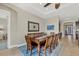 Dining room with wooden table, seating for eight, and an elegant decorative wall hanging at 23781 Waverly Cir, Venice, FL 34293