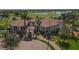 Beautiful aerial view of community clubhouse, lush landscaping, and golf course in the background at 23781 Waverly Cir, Venice, FL 34293