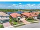Beautiful homes with brick driveways, well-manicured lawns, and serene lake views creating a picturesque setting at 23781 Waverly Cir, Venice, FL 34293