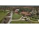 Aerial view of a beautiful golf course with lush green fairways, palm trees and pristine landscaping at 23781 Waverly Cir, Venice, FL 34293