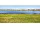 A picturesque view of a tranquil lake surrounded by lush green grass, creating a serene natural setting at 23781 Waverly Cir, Venice, FL 34293