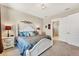 Main bedroom with a decorative headboard, ensuite bathroom and natural light at 23781 Waverly Cir, Venice, FL 34293