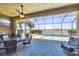 Beautiful screened lanai features an outdoor dining area with a view of the pool and waterfront at 23781 Waverly Cir, Venice, FL 34293