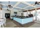 Inviting poolside bar with a bright countertop and a ceiling with multiple fans at 23781 Waverly Cir, Venice, FL 34293