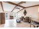 Comfortable living room featuring beamed ceilings, lots of light, and adjacent kitchen at 274 Rotonda Cir, Rotonda West, FL 33947