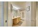 Charming bathroom featuring a vanity, toilet, shower and bath combination, decorated in a striped wallpaper and tiled floor at 409 Pine Hollow Cir # 409, Englewood, FL 34223