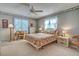 Comfortable bedroom featuring natural light from the windows, a desk, and classic furnishings at 409 Pine Hollow Cir # 409, Englewood, FL 34223