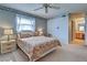 Comfortable bedroom featuring natural light from the windows, a nightstand, and classic furnishings at 409 Pine Hollow Cir # 409, Englewood, FL 34223