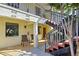 Condo building exterior featuring stairs, seating area and front doors with unit numbers at 409 Pine Hollow Cir # 409, Englewood, FL 34223