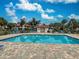 Sparkling community pool with brick accents, surrounded by lush landscaping and residences at 409 Pine Hollow Cir # 409, Englewood, FL 34223
