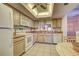 Bright eat-in kitchen featuring stainless steel sink, neutral cabinetry, and a decorative ceiling fan at 409 Pine Hollow Cir # 409, Englewood, FL 34223