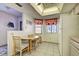 Bright eat-in kitchen with a tile floor, white appliances, and a window with charming curtains at 409 Pine Hollow Cir # 409, Englewood, FL 34223