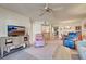 Inviting living room with TV, comfortable seating, and view to the dining area at 409 Pine Hollow Cir # 409, Englewood, FL 34223