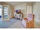 Cozy living room featuring a TV, recliner, and access to outdoor balcony and rooms within the home at 409 Pine Hollow Cir # 409, Englewood, FL 34223